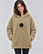 Khaki pouch hoodie worn empty, showing the chest zipper and the round opening below it