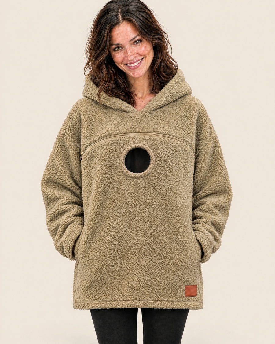 Khaki tucked pouch hoodie worn empty, showing the chest zipper and the round opening below it